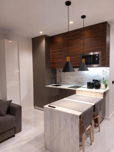 a kitchen with a table in the middle of a room at Liris Holiday Apartments in Nazaré