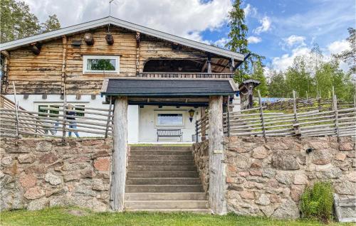 a log house with stairs leading up to it at Beautiful Home In Rimforsa With Kitchen in Rimforsa