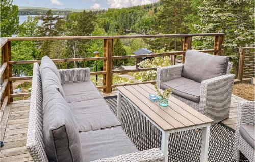 a patio with two chairs and a table on a deck at Beautiful Home In Rimforsa With Kitchen in Rimforsa