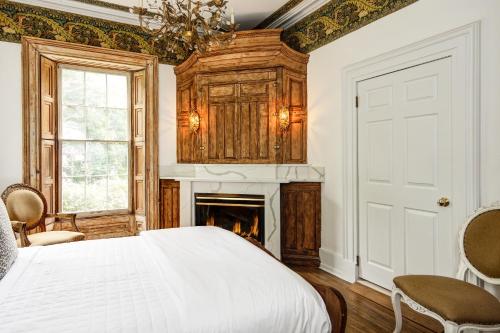 a bedroom with a bed and a fireplace at The Peninsula in Cape May Court House