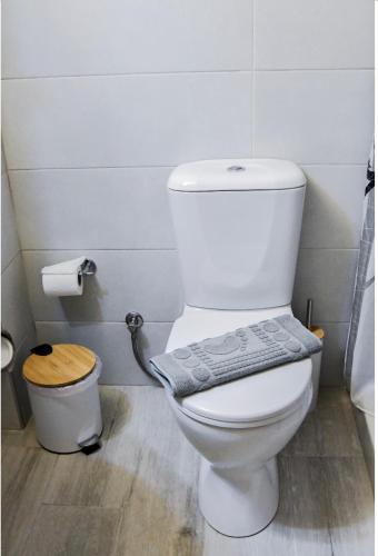 a bathroom with a toilet with a towel on it at Stone Living Symi Central Apartments in Symi