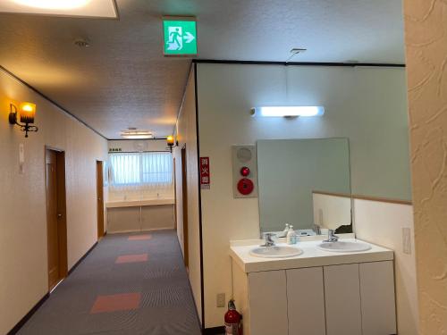 a bathroom with two sinks and a mirror at NAEBA Country Lodge in Yuzawa