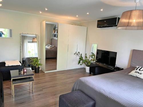 a bedroom with a bed and a living room with a couch at 4 person holiday home in VÄRMDÖ-By Traum in Värmdö