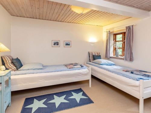 two beds in a room with stars on the walls at 6 person holiday home in Læsø-By Traum in Læsø