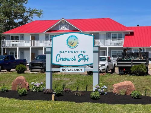 a sign in front of a mountain style motel at Gateway to Greenwich Suites in Saint Peters