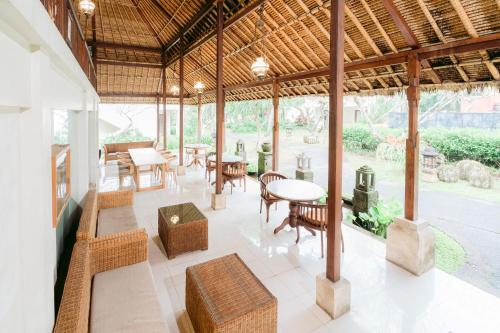 a large pavilion with tables and chairs and a table at Pertiwi Resort & Spa in Ubud
