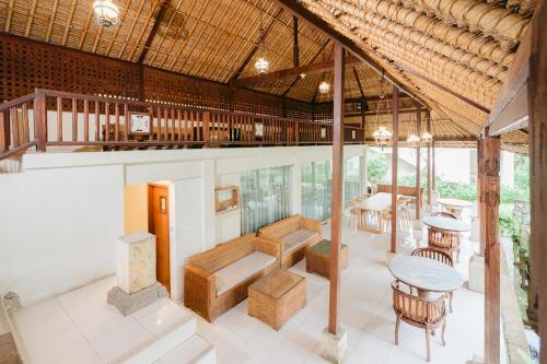 a pavilion with tables and chairs in a building at Pertiwi Resort & Spa in Ubud