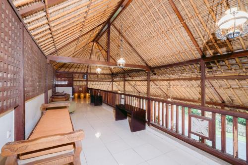 a large building with tables and benches in it at Pertiwi Resort & Spa in Ubud