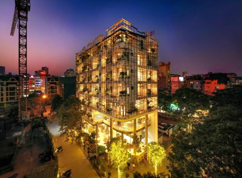 a tall building with lights in a city at night at 22Land Hotel & Residence in Hanoi