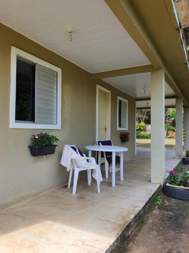 eine Veranda mit einem Tisch und Stühlen darauf in der Unterkunft Casa de charme no clima de Pedra Azul in Domingos Martins