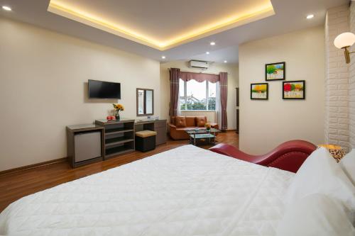 a bedroom with a white bed and a living room at New Airport Hotel in Noi Bai