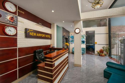 a lobby with a new airplane line with clocks on the wall at New Airport Hotel in Noi Bai