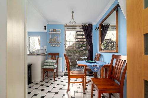 a dining room with a table and chairs at Fantastic 1 bedroom apartment with private patio in London