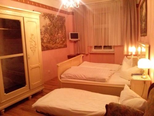 a room with two beds and a window at Hotel Prinz Eitel in Bad Ems