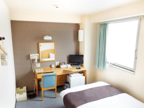 Una cama o camas en una habitación de Hotel Abest Kochi