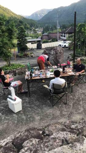a group of people sitting at a table at 癒しのwonderland 泉 in Gujo