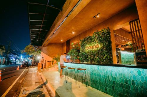 a man standing at a bar at night at Pertiwi Resort & Spa in Ubud