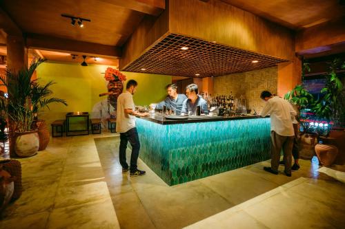 a group of men standing at a bar at Pertiwi Resort & Spa in Ubud