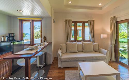 a living room with a couch and a table at The Joy Beach Villas in Hinkong