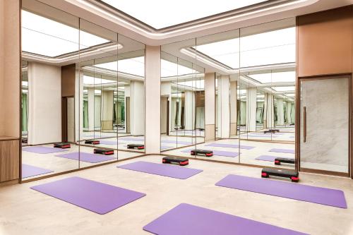 a large room with purple yoga mats at Harbour Plaza Metropolitan Shanghai in Shanghai