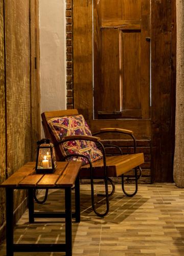 a bench and a table with a candle on it at Nienté Bali in Penebel