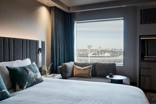A bed or beds in a room at Pullman Melbourne On the Park
