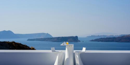 a white balcony with a view of the water at Acro Blue Luxury Villas in Akrotiri