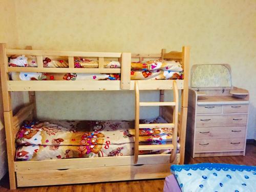 a bunk bed with two bunk beds and a desk at family apartment in Borjomi