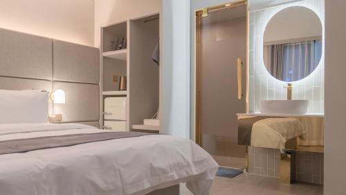 a bedroom with a bed and a mirror and a sink at Denbasta Central Hotel Seomyeon in Busan