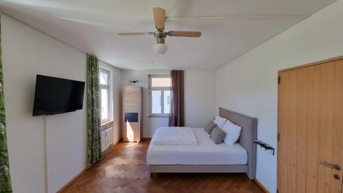 a bedroom with a bed and a flat screen tv at Gasthof - Auszeit im Bad Diezlings - Adults only in Hörbranz