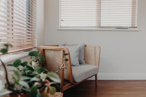 a rattan chair in a room with a window at The Allotment Albany - Centrally Located Cottage in Old Albany in Albany