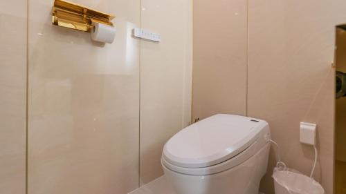 a bathroom with a white toilet and a shower at Denbasta Central Hotel Seomyeon in Busan