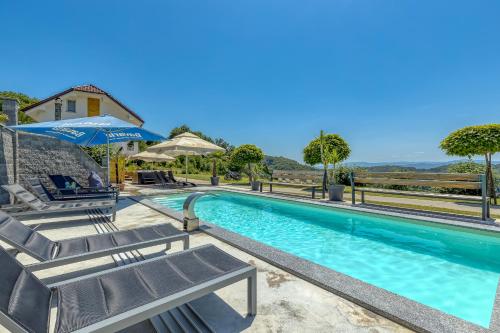 einen Pool mit Liegestühlen und ein Haus in der Unterkunft Pool & Whirlpool Art Villas - Happy Rentals in Trebnje