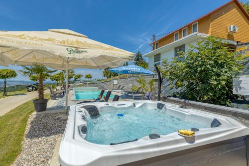a hot tub in the backyard of a house at Pool & Whirlpool Art Villas in Trebnje