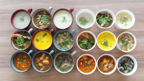 a group of bowls filled with different types of food at The BREAKFAST HOTEL MARCHE Ishigaki Island in Ishigaki Island