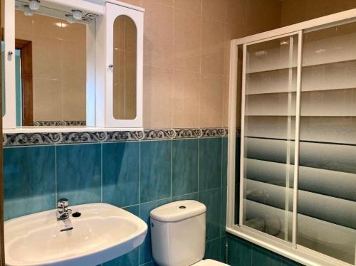 a bathroom with a toilet and a sink and a mirror at Casa la melliza VV-3021AS in Mestas de Con