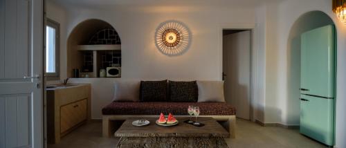 a living room with a couch and a table at Acro Blue Luxury Villas in Akrotiri