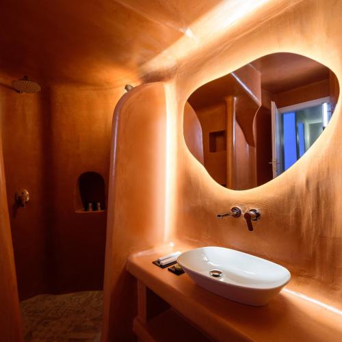 a bathroom with a sink and a mirror at Acro Blue Luxury Villas in Akrotiri