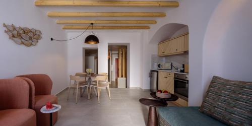 a kitchen and a living room with a table and chairs at Acro Blue Luxury Villas in Akrotiri
