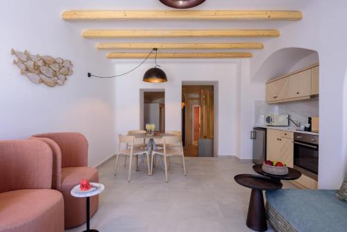 a kitchen and a living room with a table and chairs at Acro Blue Luxury Villas in Akrotiri
