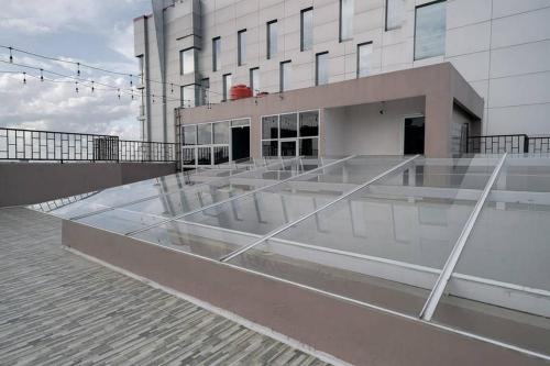 a building with a glass roof on top of it at Urbanview Hotel Bari Syariah Palembang By RedDoorz in Sukarami
