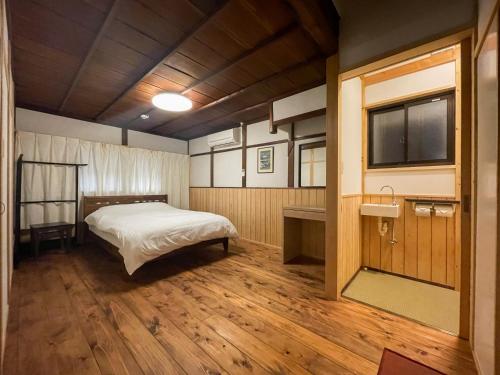 a bedroom with a bed in the middle of a room at Kurodani House in Kyoto