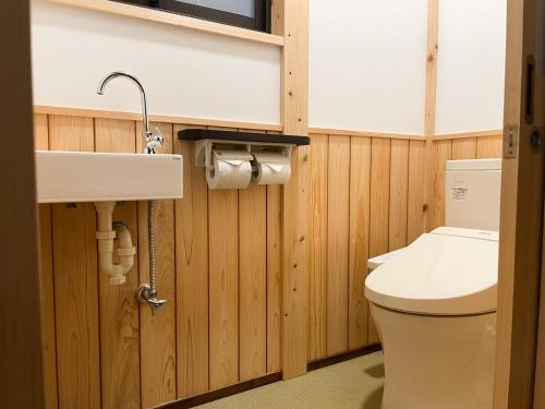 a bathroom with a toilet and a sink at Kurodani House in Kyoto