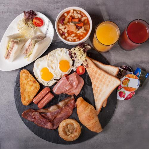 a plate of breakfast food with eggs sausage and beans at B P International in Hong Kong