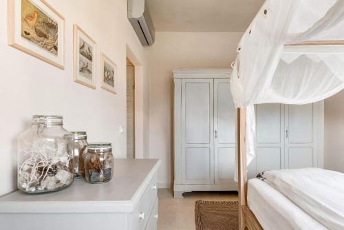 a bedroom with a bed and a table with jars on it at Wp Relais apartments in Diso