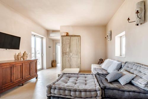 a living room with a large bed and a couch at Wp Relais apartments in Diso