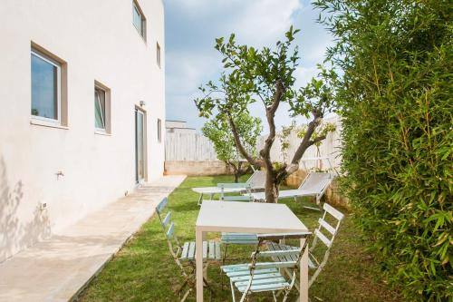 a row of tables and chairs in a yard at Wp Relais apartments in Diso