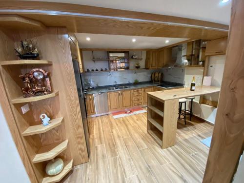 a kitchen with wooden cabinets and a table in it at B & B Pogradec in Pogradec