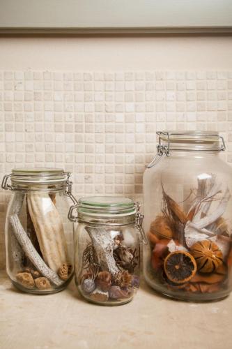 three glass jars filled with different types of nuts at Wp Relais apartments in Diso