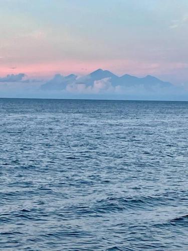 a large body of water with mountains in the background at Serene 2 BR Villa Private Pool in Top Diving Area in Kubu